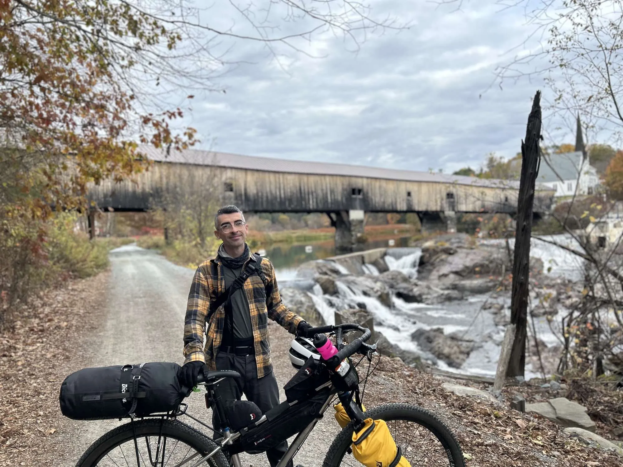 Me and my bike in front of a covered bridge